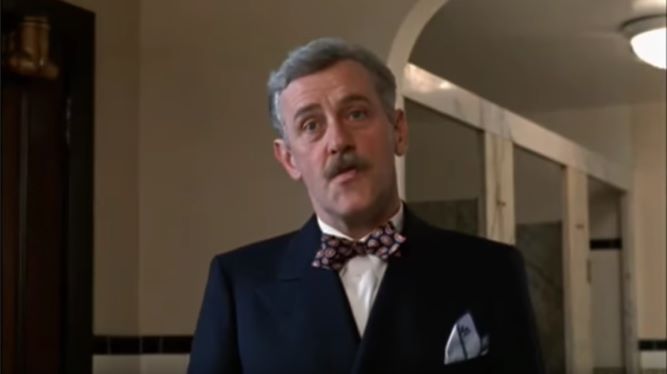 John Mahoney as E. W. Mayhew